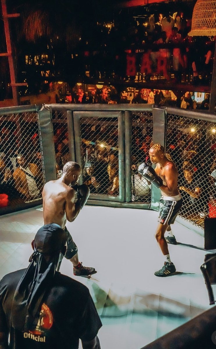 Fight Night bout in the cage above the crowd