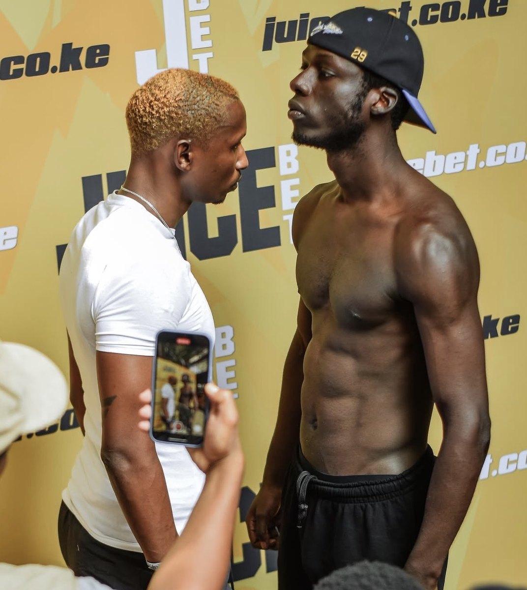 Fight Night weigh-in face-off in front of the Juicebet wall